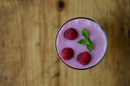 fresh organic raspberry smoothie on wooden tableの写真素材