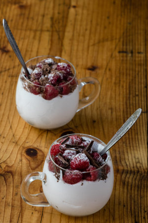 Raspberry whit chocolate on whipped cream in a glassの写真素材