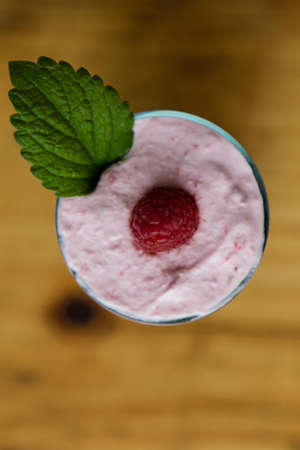 fresh organic raspberry cream dessert on wooden tableの写真素材