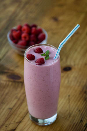 fresh organic raspberry smoothie on wooden tableの写真素材