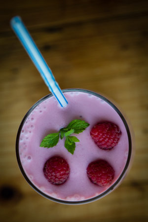 fresh organic raspberry smoothie on wooden tableの写真素材