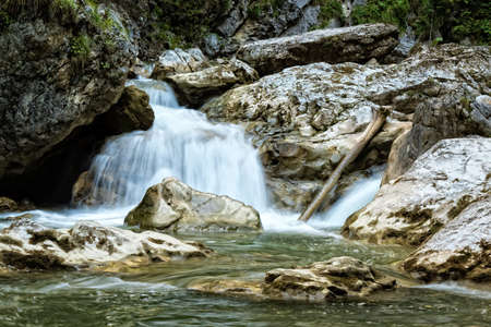 Raging clean fresh mountain river flowing between rocksの写真素材