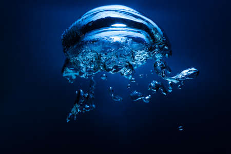 abstract underwater oxygen bubble with blue backdropの写真素材