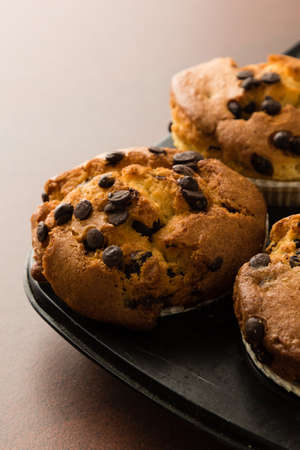 freshly baked chocolate chip muffins in black panの写真素材