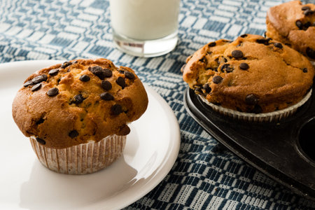 freshly baked chocolate chip muffins on tableの写真素材