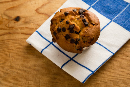 fresh chocolate chip muffin on table clothの写真素材