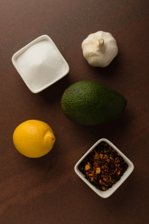 fresh healthy green avocado fruit with lemon, onion and condiments