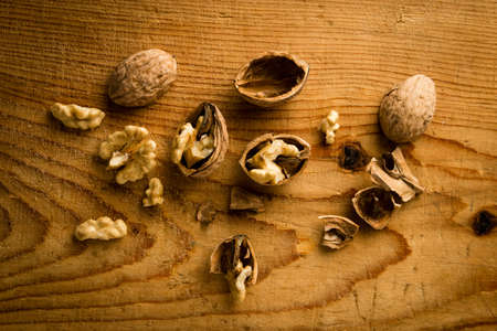 raw brown broken natural rustic walnuts on tableの写真素材