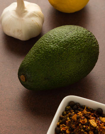 fresh healthy green avocado fruit with lemon, onion and condimentsの写真素材