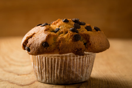 fresh chocolate chip muffin on wooden tableの写真素材
