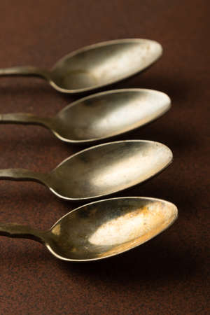 retro vintage used old spoons on a tableの写真素材