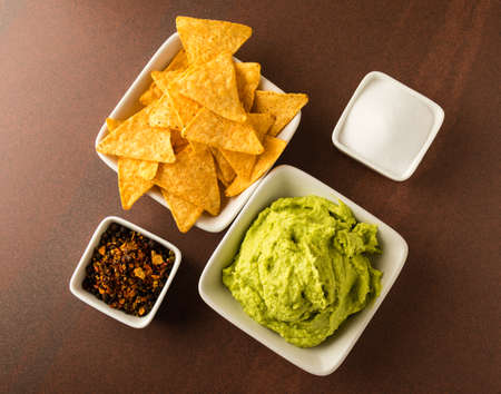 fresh organic guacamole with tortilla chips and seasoningの写真素材