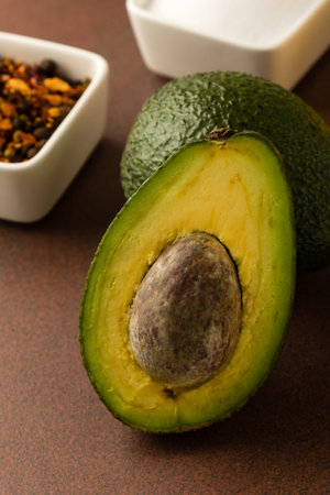 fresh healthy green avocado fruit cut in half with seed