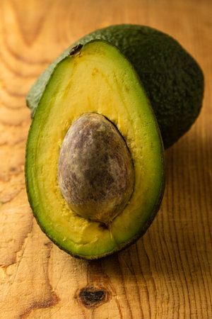 fresh healthy green avocado fruit cut in half with seed