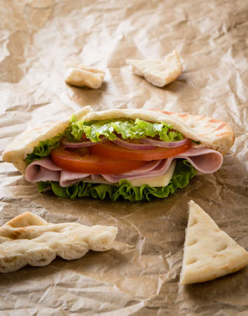 fresh pita ham sandwich on brown paperの写真素材