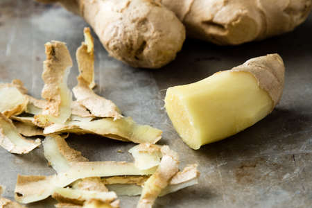 fresh healthy sliced ginger root on steel plateの写真素材
