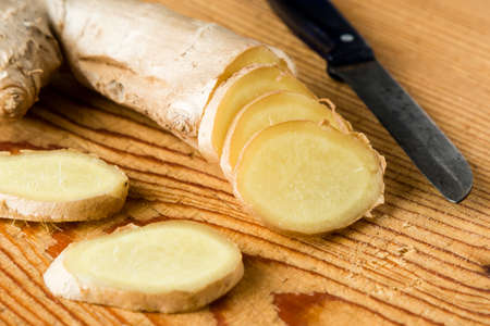 fresh healthy sliced ginger root on tableの写真素材