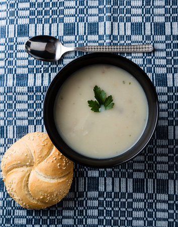 fresh healthy champignon soup in black bowl
