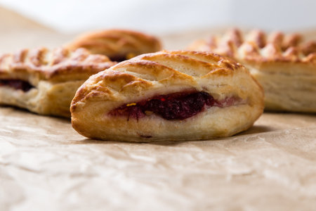 fresh puff pastry with jam on baking paper