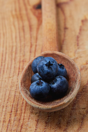 fresh blue organic blueberry in wooden spoonの写真素材