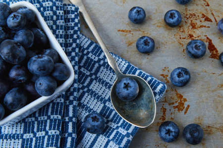 blueberries on table in spoon and bowlの写真素材
