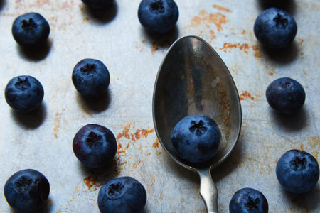 blueberries on steel plate and in spoon