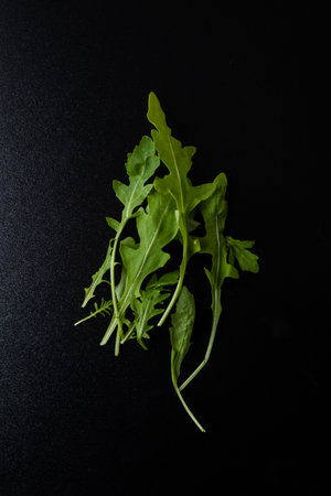 green organic rucola leafs on a black table