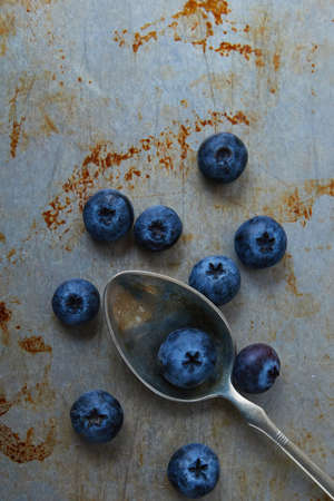 blueberries on steel plate and in spoonの写真素材