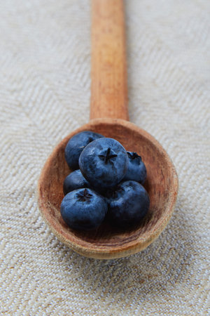 fresh blue organic blueberry in wooden spoonの写真素材