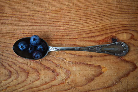 fresh blue organic blueberry in vintage spoonの写真素材