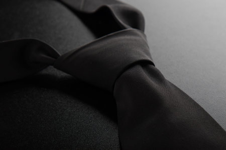 elegant casual black neck tie on black table