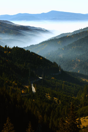 morning mountain valley landscape in autumn with fog