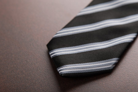 elegant business tie whit stripes on table