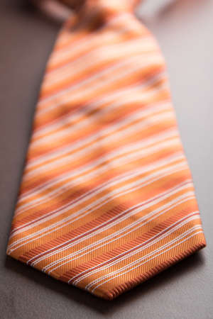 elegant casual orange neck tie on tableの写真素材
