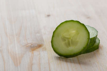fresh natural sliced raw cucumber on cuttingboardの写真素材
