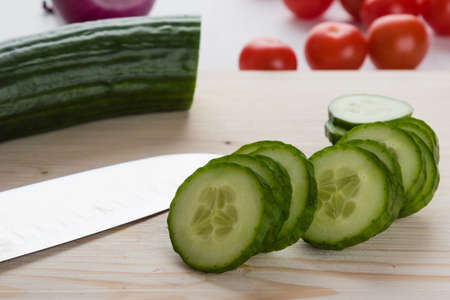 fresh natural sliced raw cucumber on cutting boardの写真素材