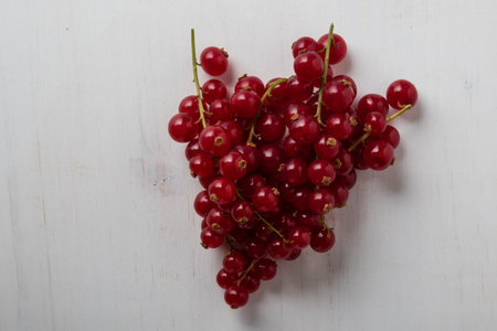 fresh ripe red currant on white table