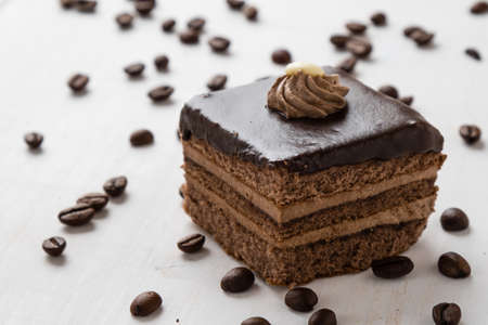 brown chocolate cake and coffee beans on tableの写真素材