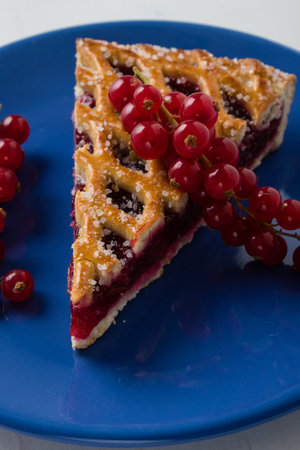 fresh cherry pie with currant on blue plateの写真素材