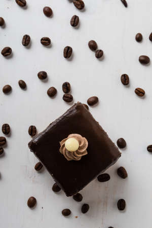 brown chocolate cake and coffee beans on tableの写真素材