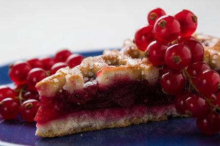 fresh cherry pie with currant on blue plate