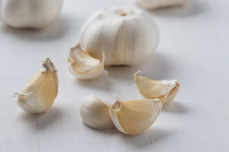 natural healthy garlic on white wooden tableの写真素材
