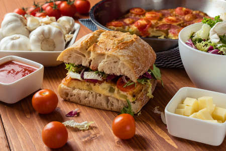 big frittata ciabatta sandwich on breakfast tableの写真素材