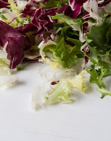 colorful chopped lettuce on white wooden table