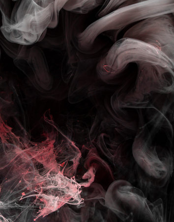 Abstract acrylic black and red paint swirls in waterの写真素材