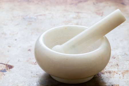 ceramic white mortar tool on steel plateの写真素材