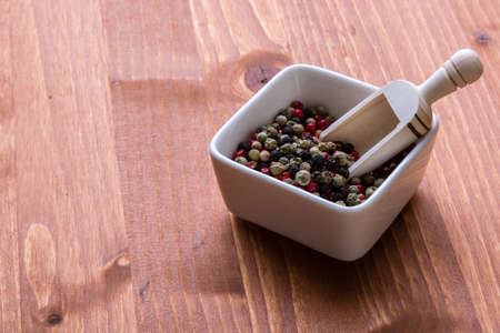 mixture of color peppercorn seeds in a bowlの写真素材