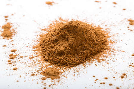 brown cinnamon condiment powder on white tableの写真素材