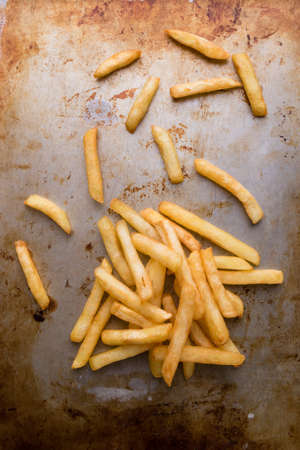 fresh yellow fries on grungy steel plateの写真素材