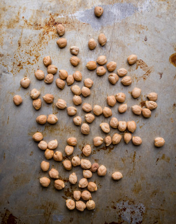 dry brown chickpeas scattered on steel plate